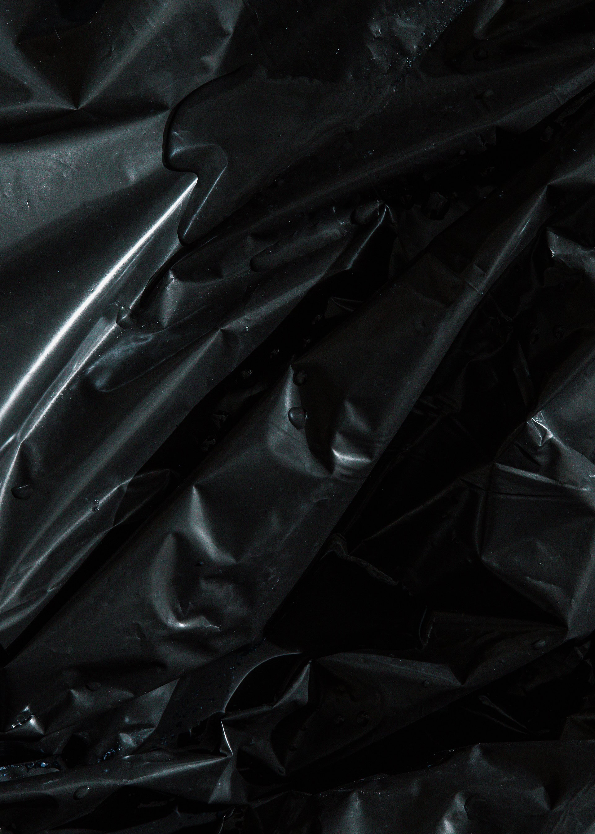 Background of black crumpled plastic bag